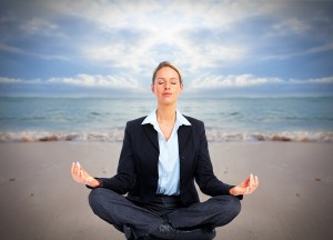 Business woman doing yoga on the beach. Vacation.